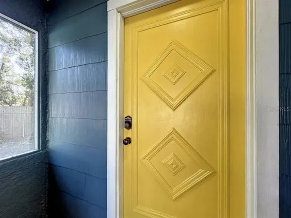 a workspace room with furniture and a window