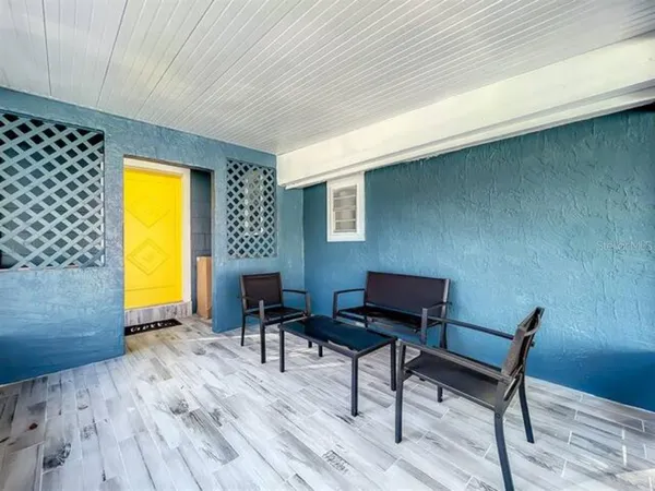 a living room with furniture and a floor to ceiling window