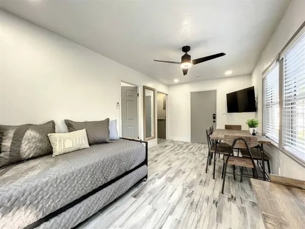 a bedroom with a bed and a flat screen tv