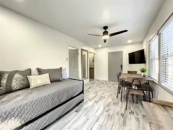 a living room with furniture and wooden floor