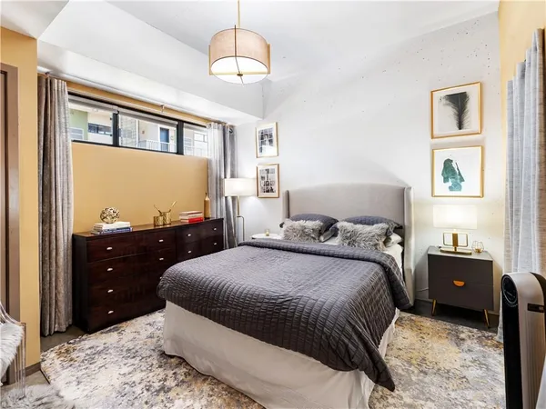 a bedroom with a bed and a chandelier