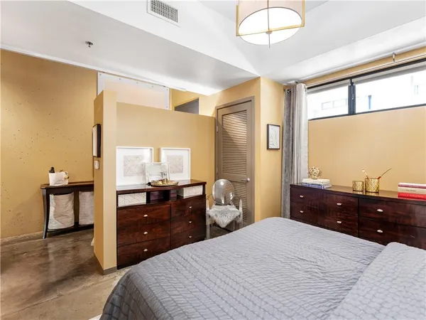 a bedroom with a bed and a dresser