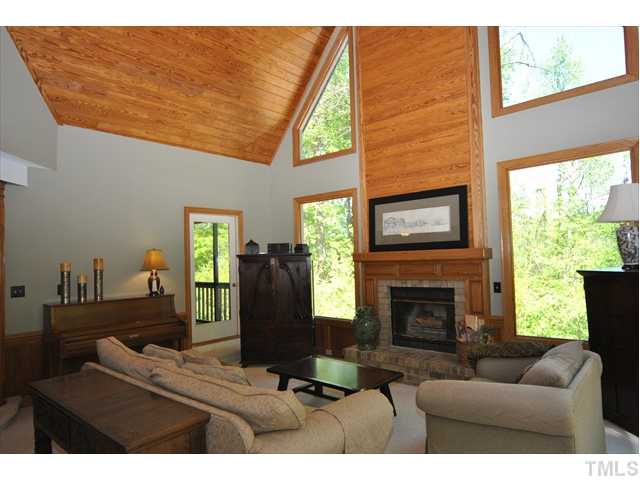 7900 Tulip Circle Raleigh, NC 27606 - Photo 2 of 9 Family Room with Fireplace, soaring tongue and groove ceilings, beautiful and large picture windows and magnificent view of nature