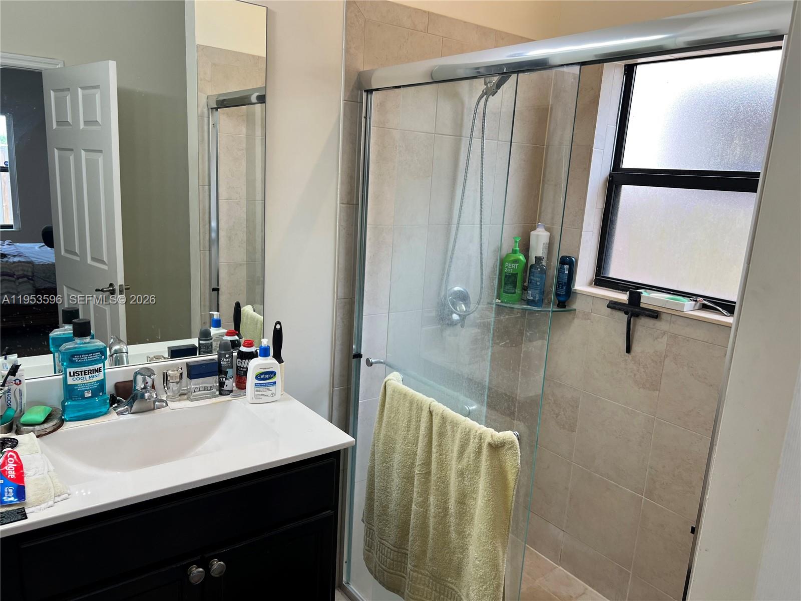 134 Northeast 23rd Terrace Homestead, FL 33033 - Photo 11 of 17 a bathroom with a sink and a mirror