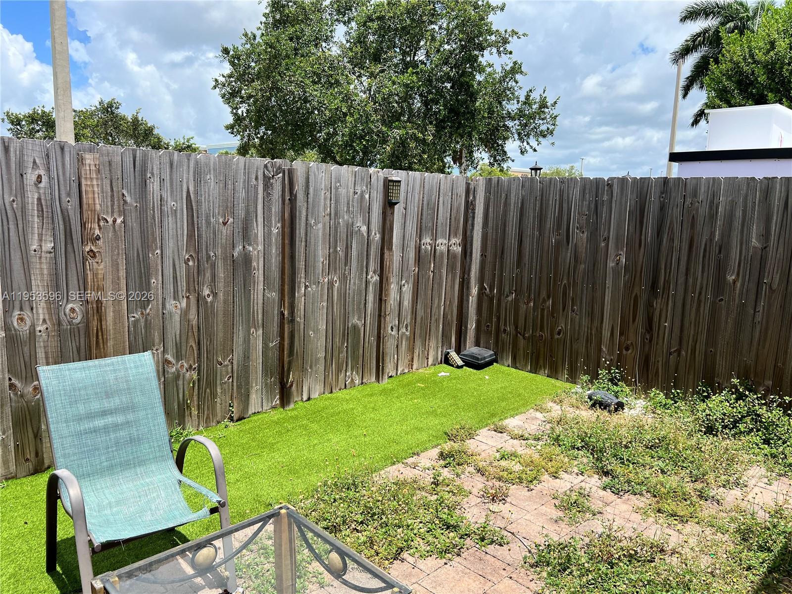 134 Northeast 23rd Terrace Homestead, FL 33033 - Photo 15 of 17 a garden with wooden fence