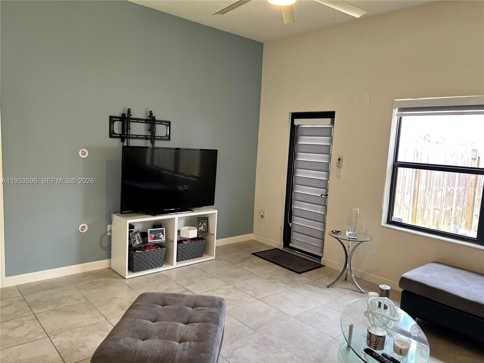 134 Northeast 23rd Terrace Homestead, FL 33033 - Photo 3 of 17 a living room with furniture and a flat screen tv