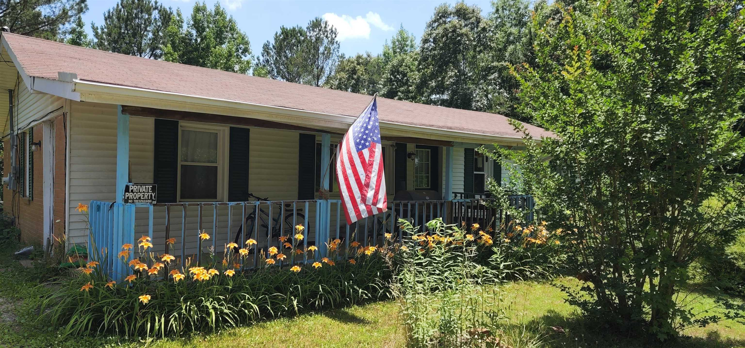 60 McAbee Road Jackson, TN 38301 - Photo 1 of 18 a view of a house with a flower garden