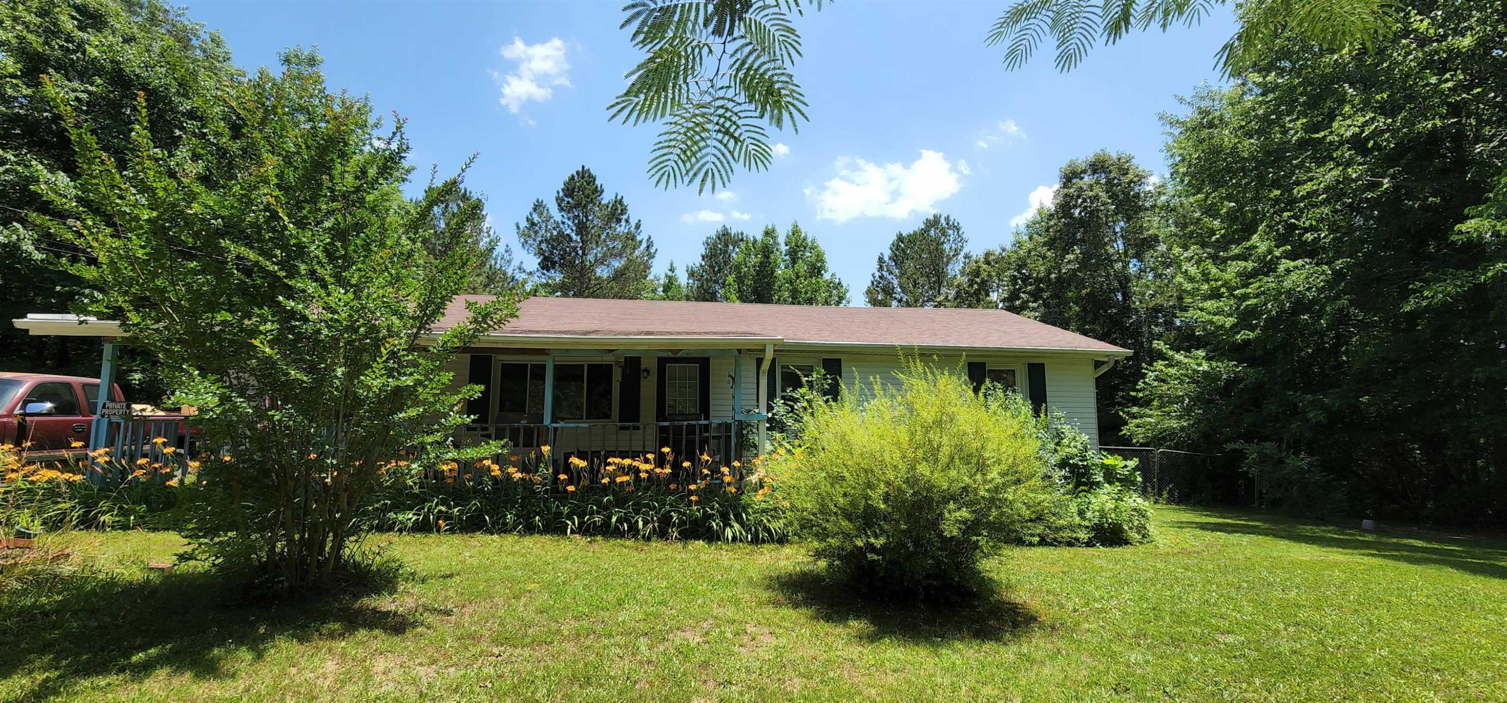 60 McAbee Road Jackson, TN 38301 - Photo 3 of 18 a view of a house with a yard and potted plants