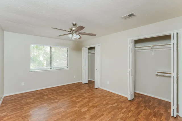 a bathroom with a double vanity sink a toilet and a shower