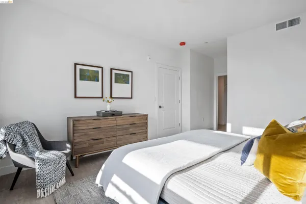 a bedroom with a bed and a chair