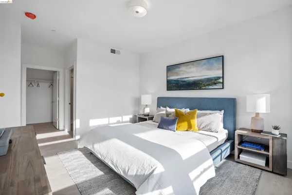 a bedroom with a bed and a night stand