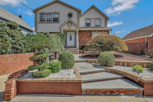 front view of a house with potted plants
