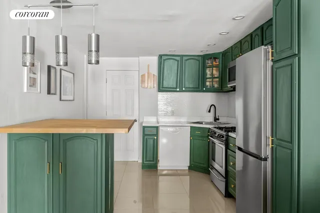 a living room with furniture and a baby crib