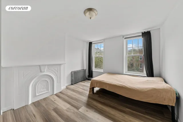 a bedroom with furniture and a wooden floor