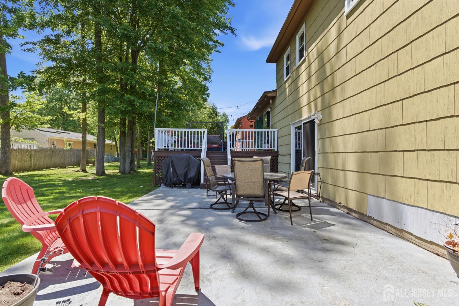 213 Normandy Road Edison, NJ 08820 - Photo 43 of 45 a view of a patio with table and chairs with wooden fence and plants