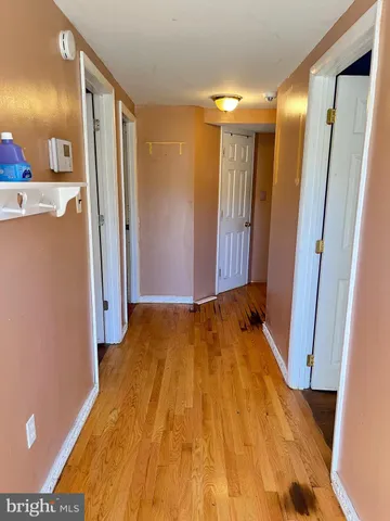 a view of a room with wooden floor and a bathroom
