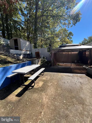 a view of a backyard with chairs and a fire pit