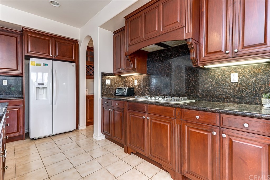 30 Paso Robles Irvine, CA 92602 - Photo 21 of 34 a kitchen with stainless steel appliances granite countertop a refrigerator and a sink