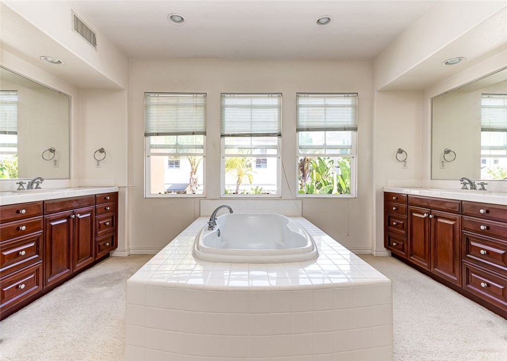 30 Paso Robles Irvine, CA 92602 - Photo 29 of 34 a spacious bathroom with a granite countertop tub sink and mirror