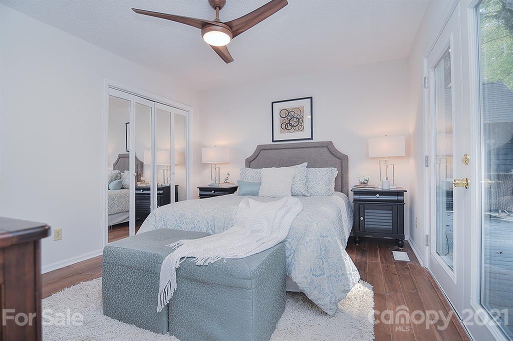 3499 Lake Shore Road South Denver, NC 28037 - Photo 24 of 35 a bedroom with a large bed and a chandelier