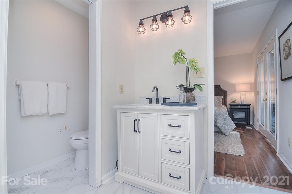 3499 Lake Shore Road South Denver, NC 28037 - Photo 26 of 35 a bathroom with a sink a toilet and shower