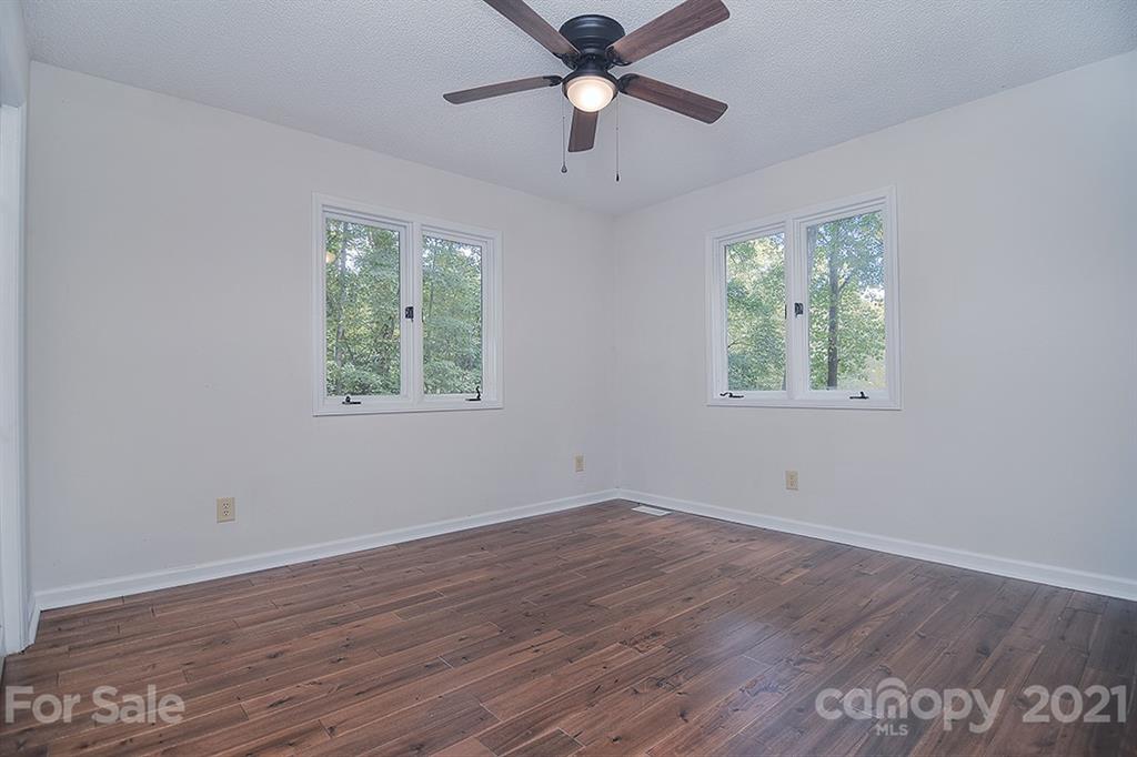 3499 Lake Shore Road South Denver, NC 28037 - Photo 27 of 35 a view of an empty room with wooden floor and a window
