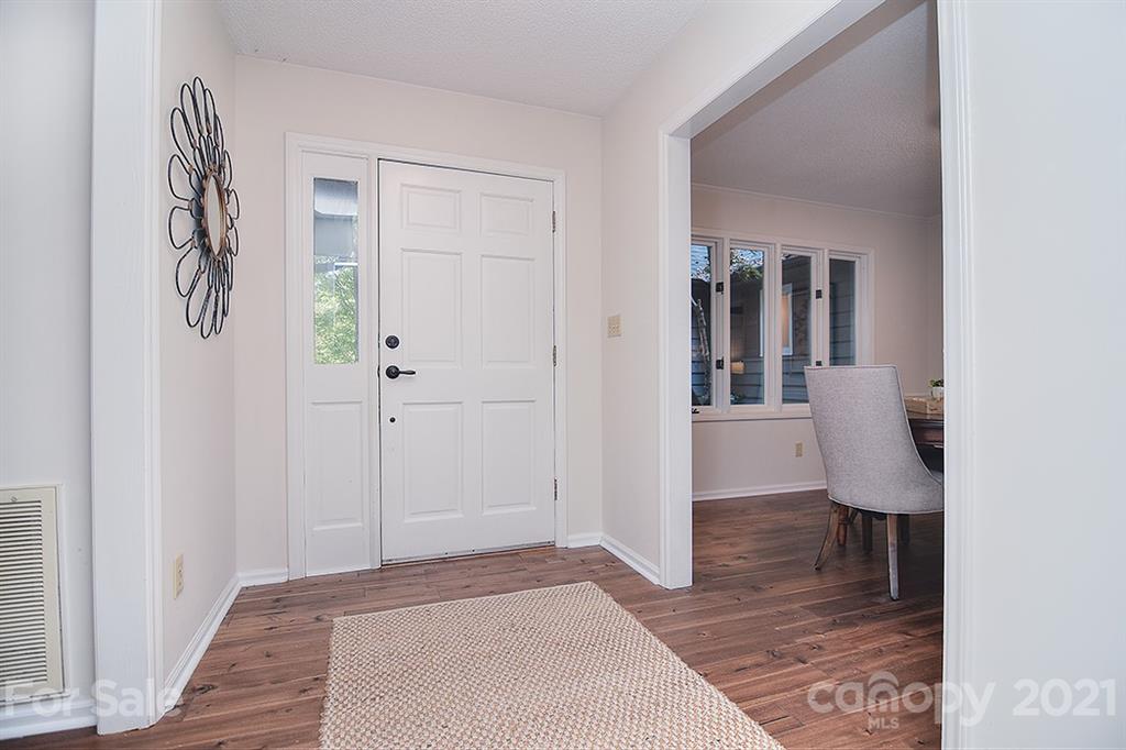 3499 Lake Shore Road South Denver, NC 28037 - Photo 4 of 35 a view of a hallway with wooden floor and a living room