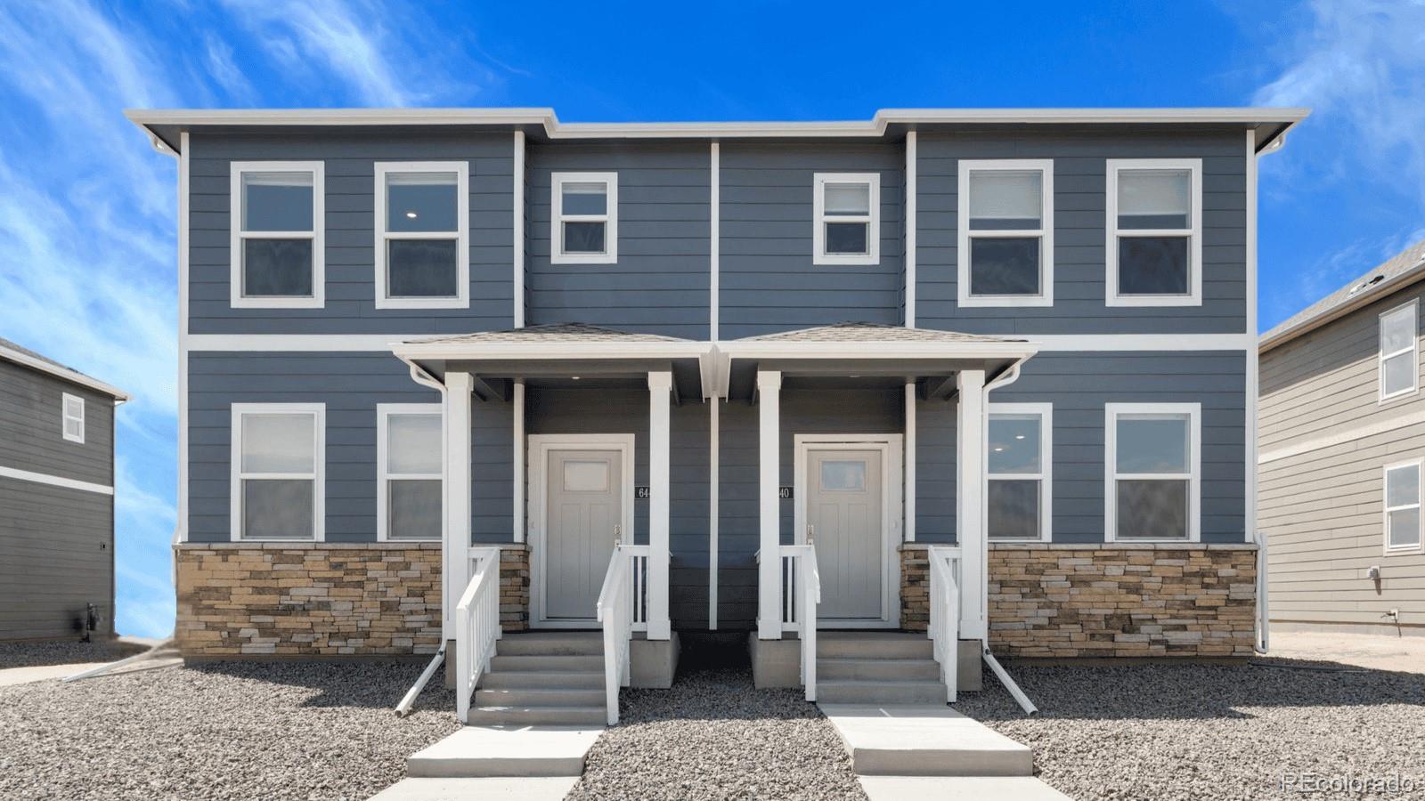 a view of a brick house with large windows