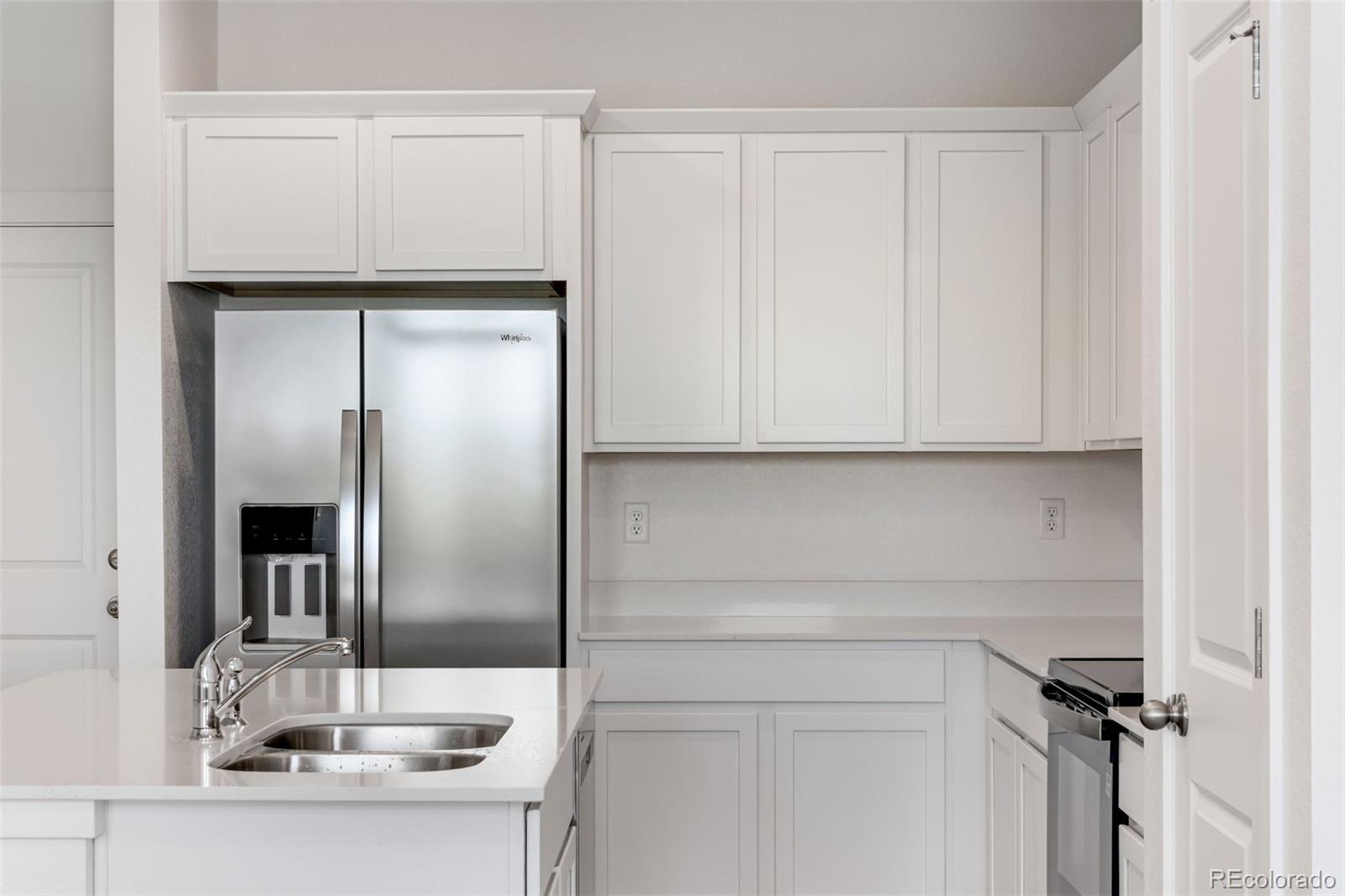 2344 Merlot Street Fort Lupton, CO 80621 - Photo 11 of 23 a kitchen with a sink and cabinets