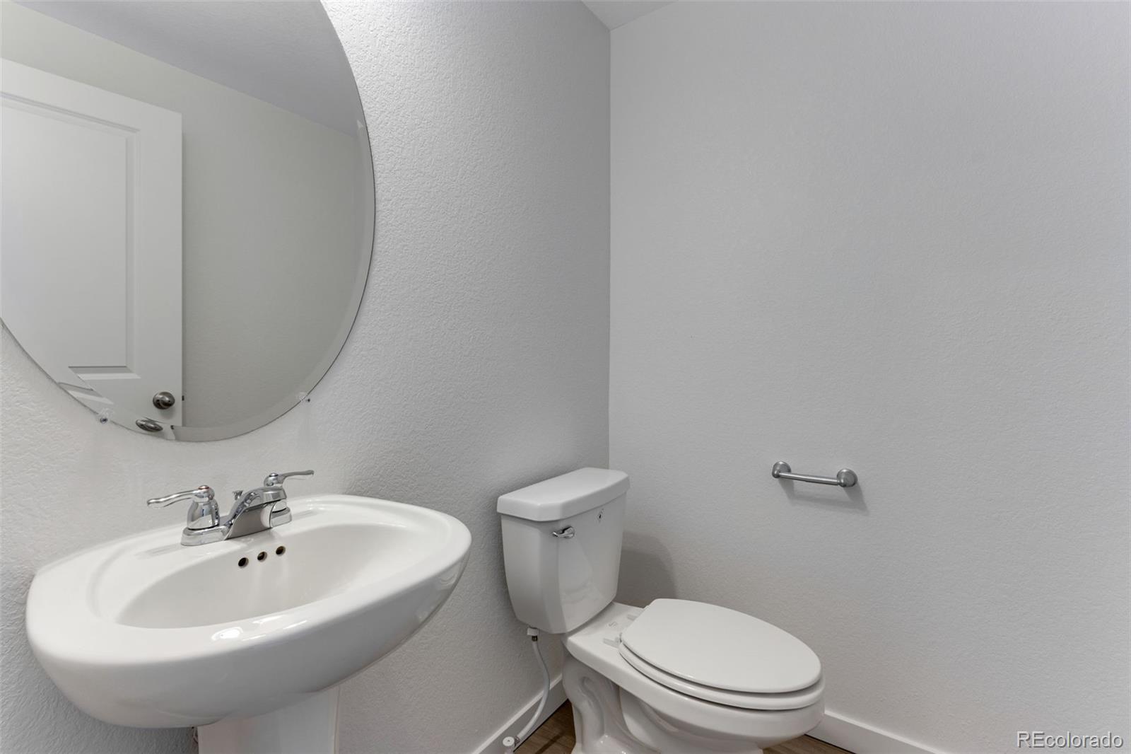 2344 Merlot Street Fort Lupton, CO 80621 - Photo 12 of 23 a bathroom with a sink a mirror and a toilet