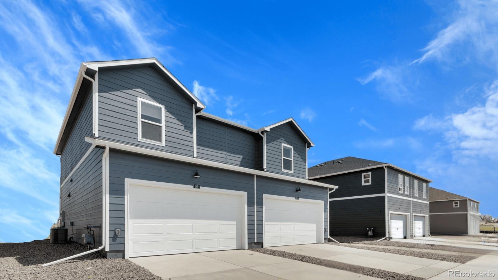 2344 Merlot Street Fort Lupton, CO 80621 - Photo 22 of 23 a front view of a house with a garage