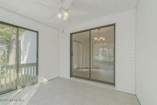 an empty room with closet and fan