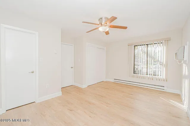 a bedroom with a bed and a potted plant