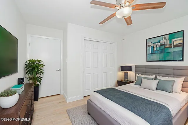 a green field with lots of trees in the background