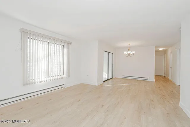 a living room with furniture wooden floor and a large window