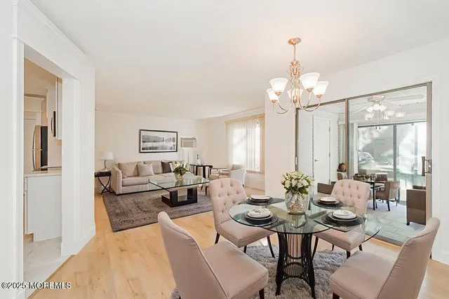 a kitchen with stainless steel appliances granite countertop a sink and a stove top oven with wooden floor