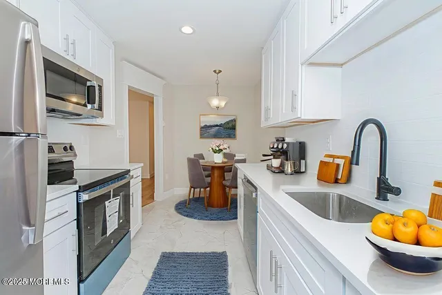 a kitchen with a refrigerator stove and microwave