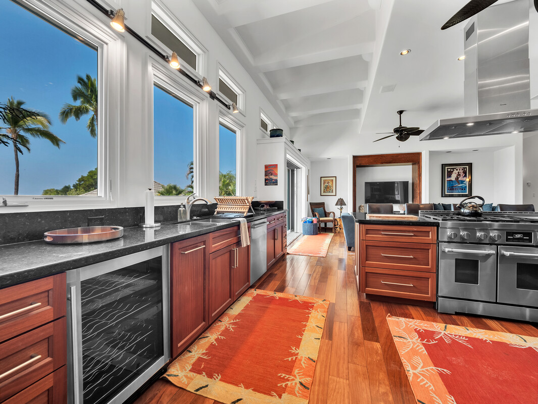 59-128 Olomana Road Kamuela, HI 96743 - Photo 9 of 30 a large kitchen with stainless steel appliances granite countertop a stove and cabinets