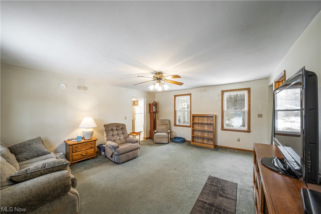 7541 Cooley Road Ravenna, OH 44266 - Photo 24 of 32 Living room featuring ceiling fan and light colored carpet