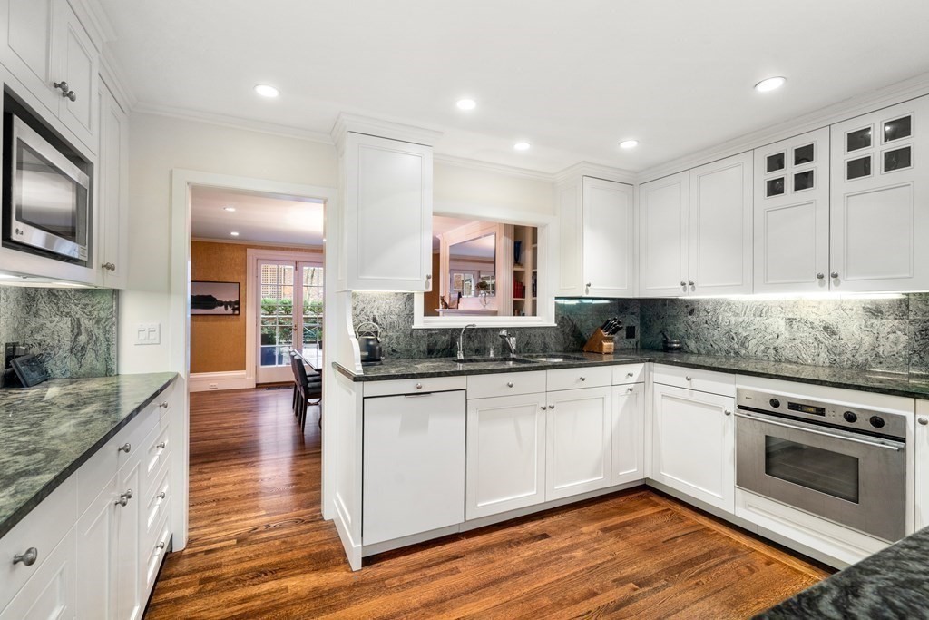 17 West Cedar Street Boston, MA 02108 - Photo 18 of 42 a large kitchen with stainless steel appliances granite countertop a stove and a sink