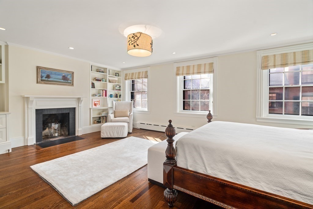17 West Cedar Street Boston, MA 02108 - Photo 20 of 42 a bedroom with a bed and a fireplace