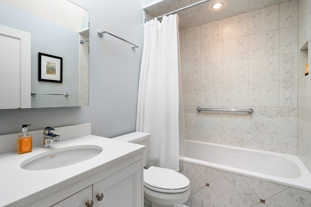 17 West Cedar Street Boston, MA 02108 - Photo 29 of 42 a bathroom with a sink a toilet and shower
