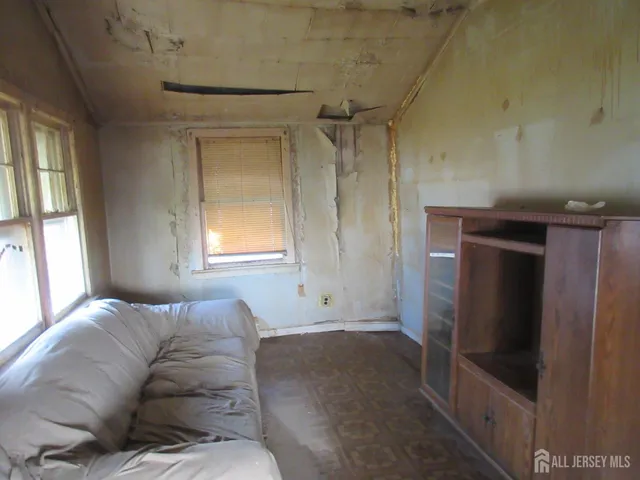 a living room with a couch and a dresser