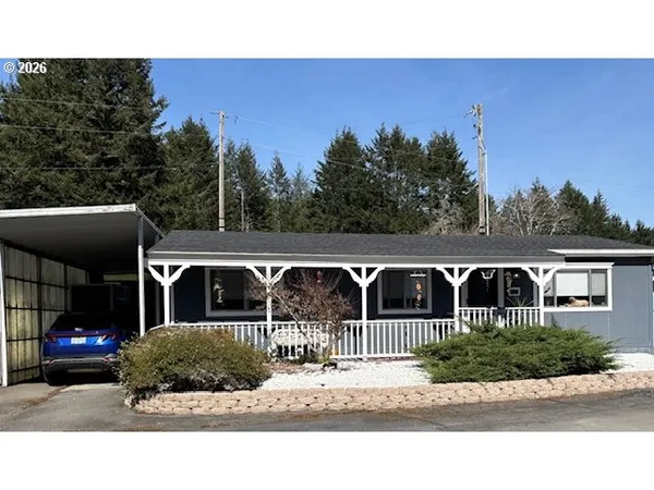 a view of house with outdoor space and parking