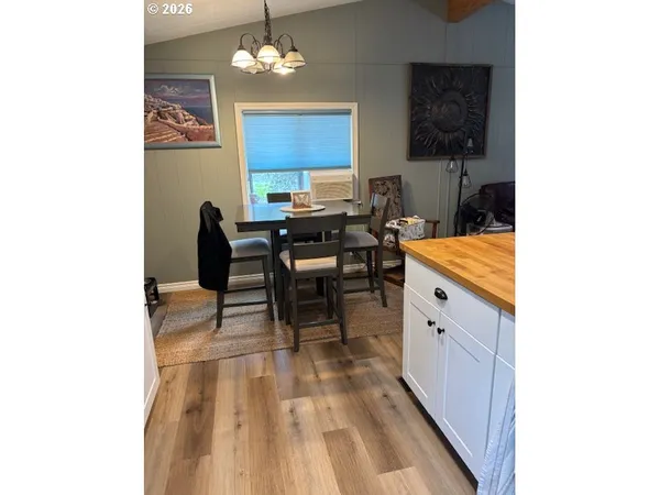 a view of a dining room with furniture and chandelier