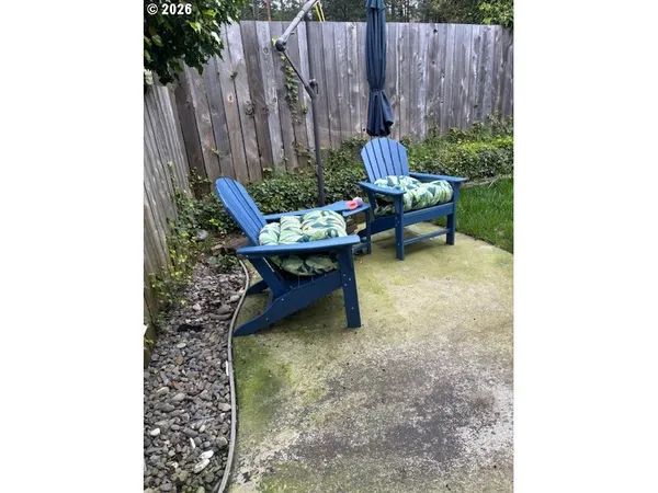 a backyard of a house with chairs and a yard
