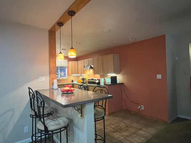 a view of a dining room with furniture and a potted plant