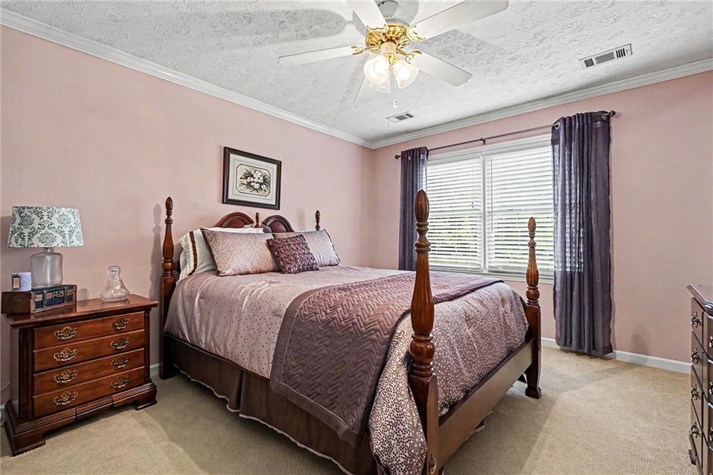 740 Smyrna Road Southwest Conyers, GA 30094 - Photo 18 of 27 a bedroom with a bed and a chandelier