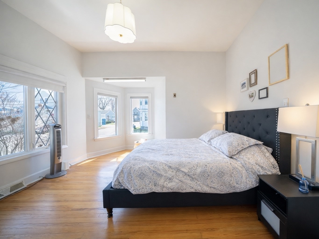 10 Guild Road Saugus, MA 01906 - Photo 15 of 32 a bedroom with a bed and wooden floor