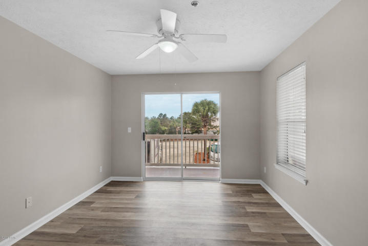 17690 Front Beach Road, Unit D207 Panama City Beach, FL 32413 - Photo 25 of 28 an empty room with wooden floor and windows